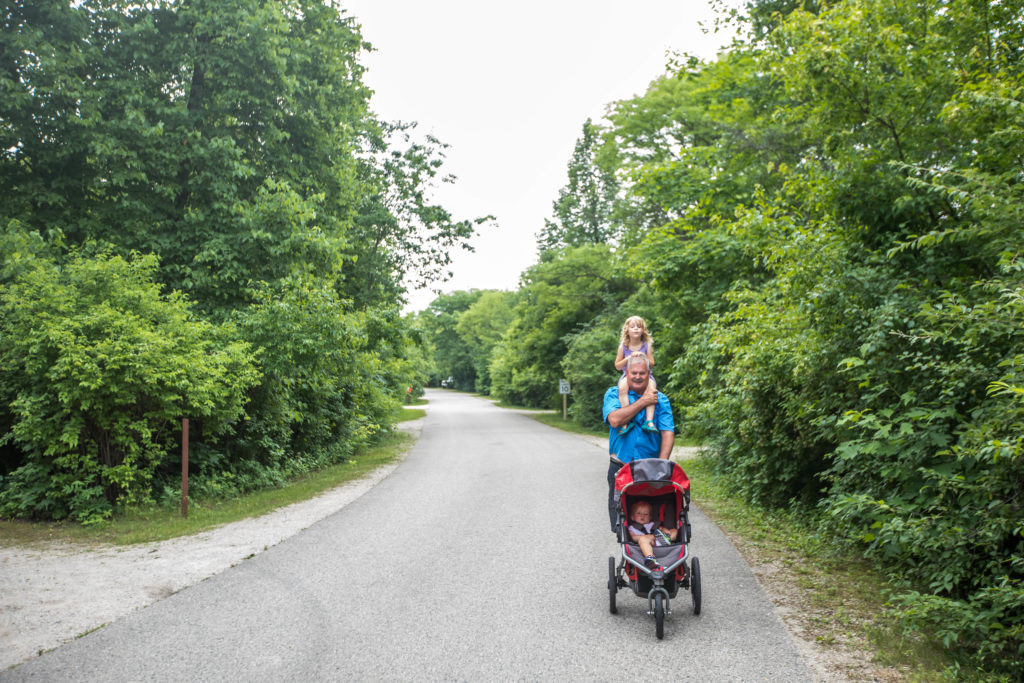 1 year old and 4 year old take a walk around campground with a BOB Stroller