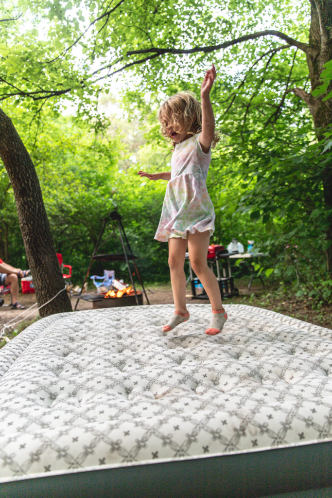 4-year old jumping on an air mattress while tent camping | camping activities for kids