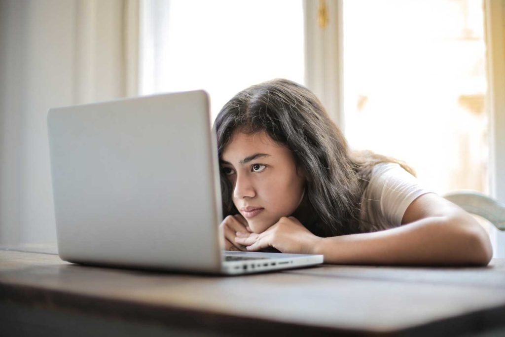 Woman bored working at her computer from home