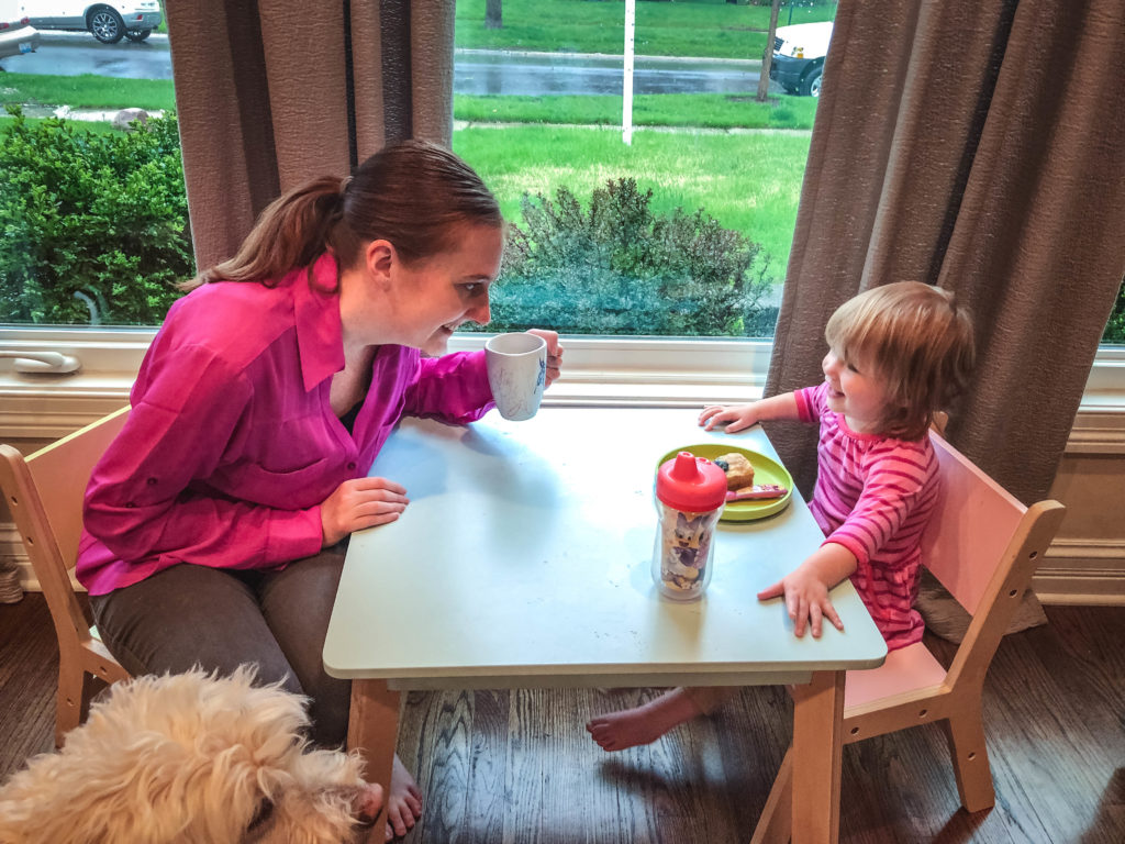 mom takes a lunch break with two year old while working from home with a toddler