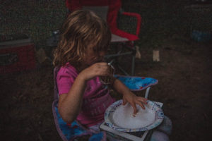 4 year old girl eats a cookie smore while tent camping | camping activities with kids