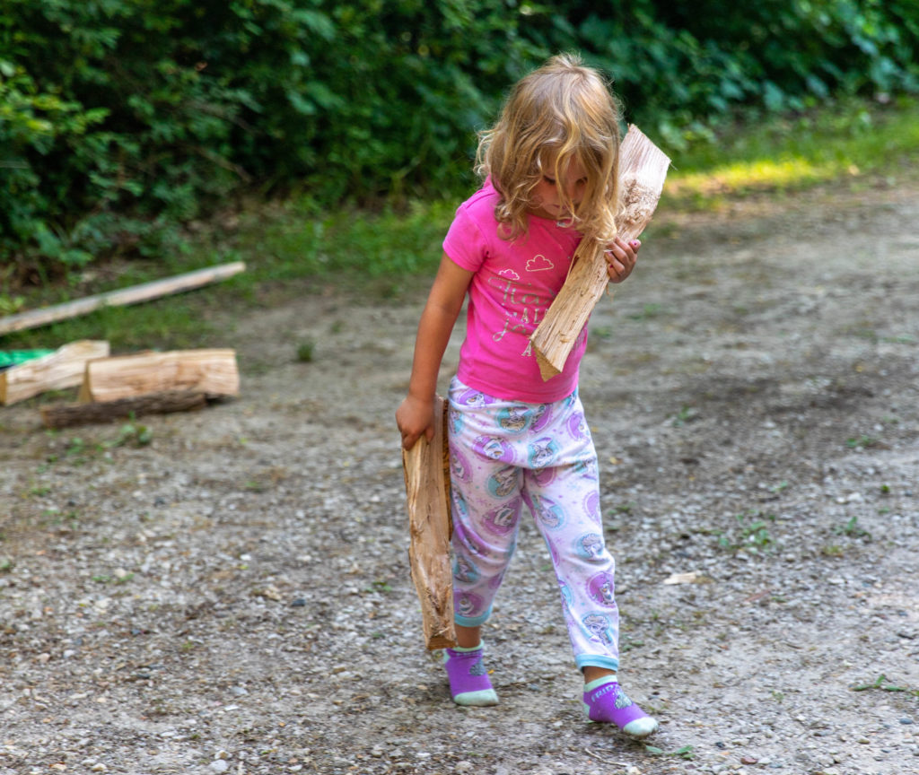 4 year old helping with chores while camping