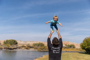 Dad and son playing by the river at the longhorn ranch rv resort in Dubois, WY