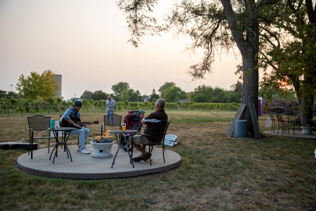 family hanging out around a fire as Harvest Host guests at Mac's Creek Brewery in Nebraska