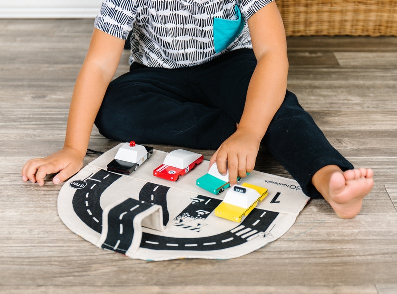 Car play mat for toddlers that can also be used for toy car storage