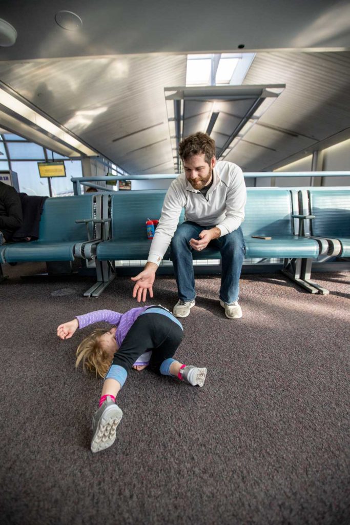 Dad and daughter at Chicago's Ohare Airport waiting for a flight