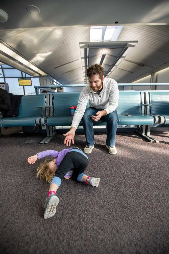 Dad and daughter at Chicago's Ohare Airport waiting for a flight