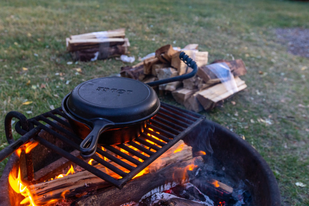 Cooking over campfire during summer camping trip