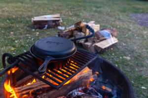 Cooking over campfire during summer camping trip