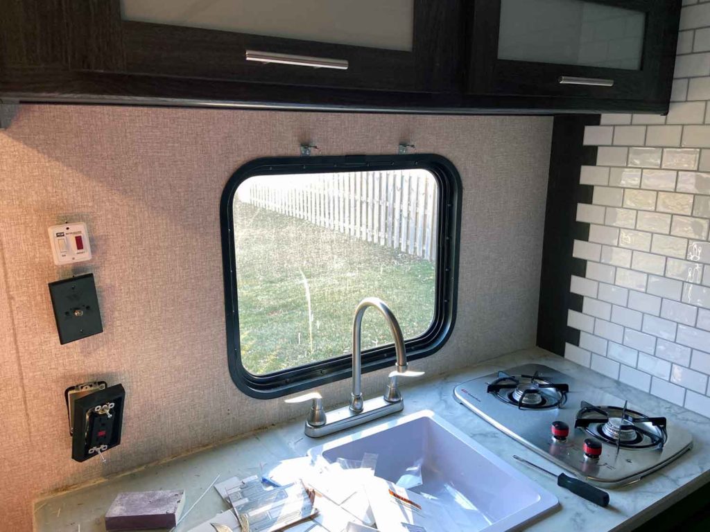 Installing a tile backsplash in an RV means removing old materials