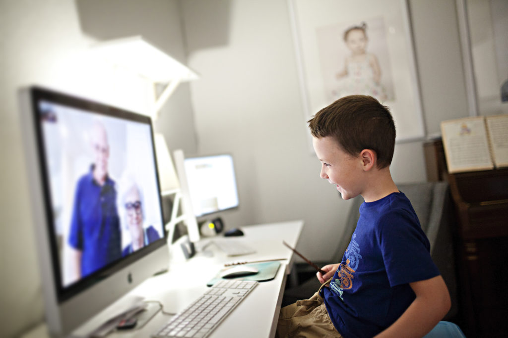 toddler boy talking to grandparents over facetime