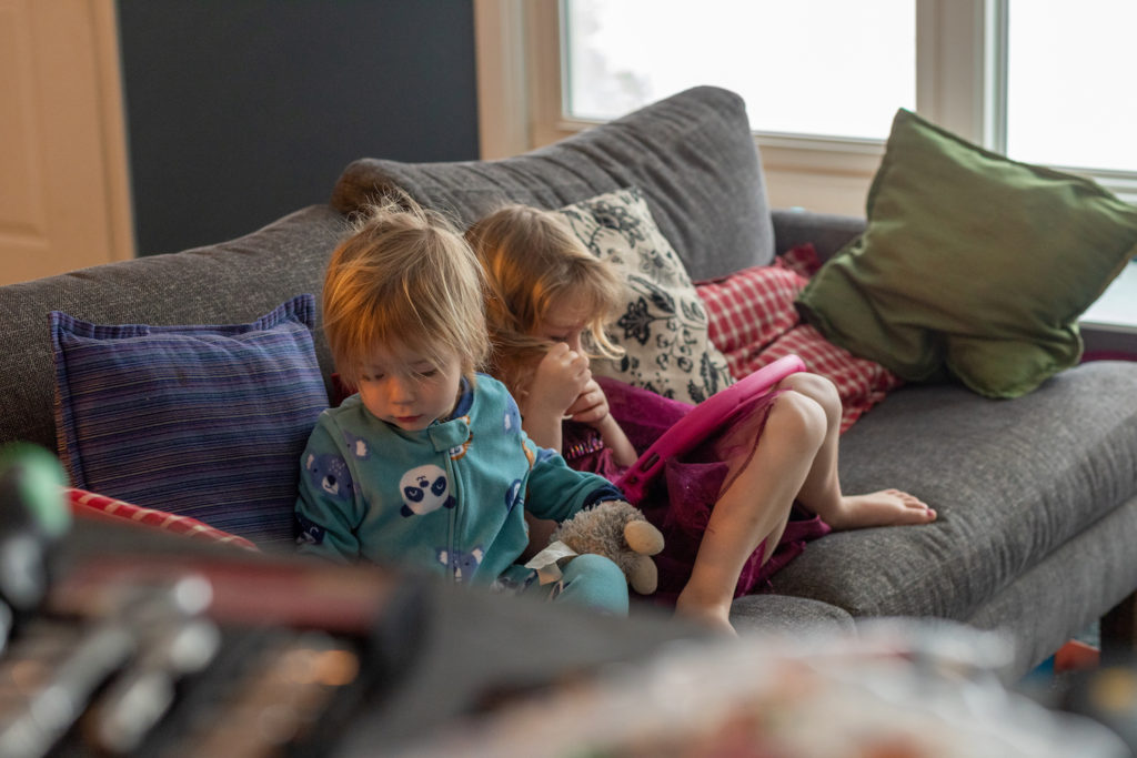 Two young kids watching ipad