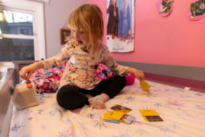 4-year-old playing with screen free audio device Yoto