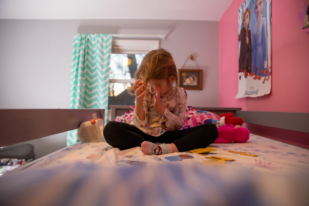 4-year-old listening to Yoto screen free audio device before bedtime