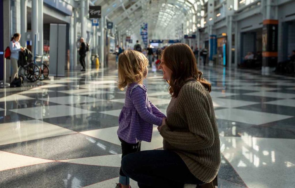 mom talking to daughter at airport