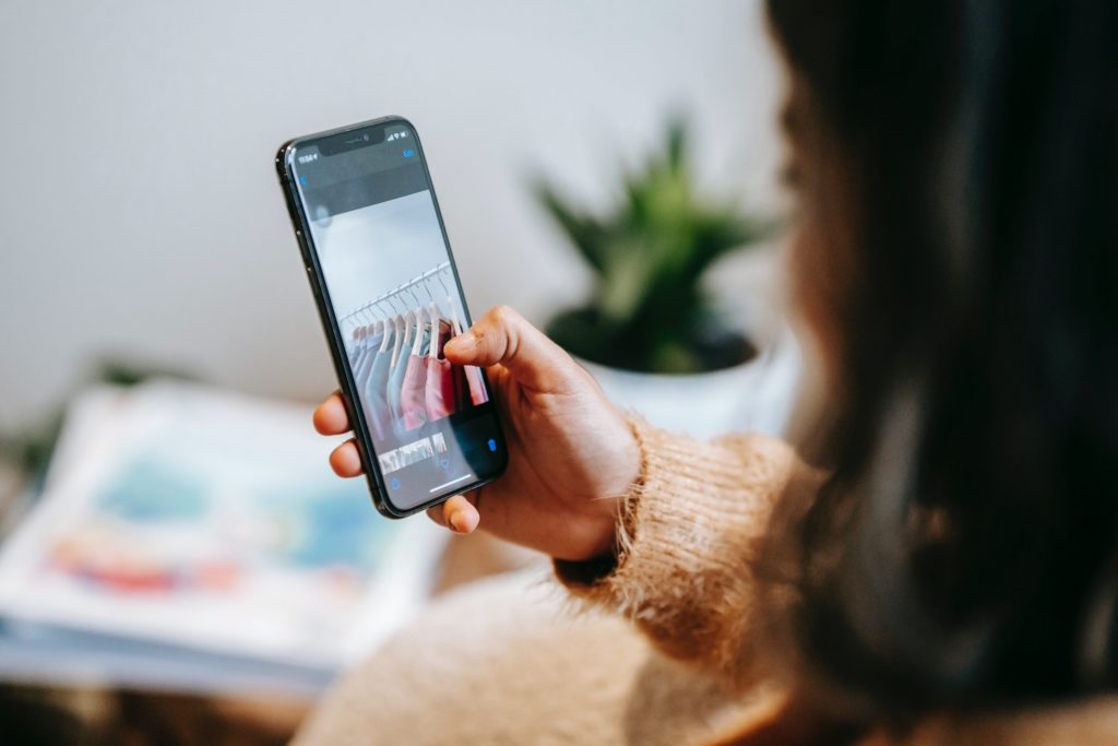 woman checks email while walking