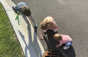 three kids playing outside with sensory toys