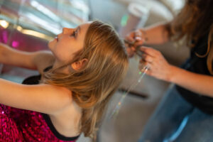girl getting hair done during taylor swift birthday party